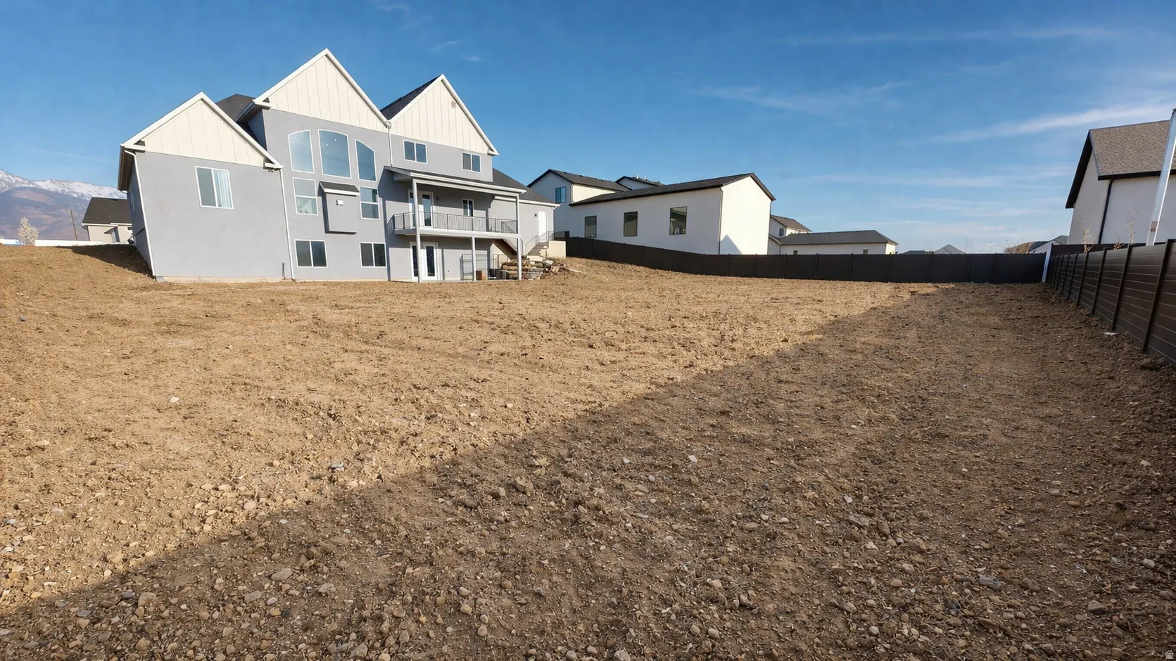 This is an Ai enhanced Photo. Expansive lot with a newly constructed residence featuring a multi-level design and a rear balcony