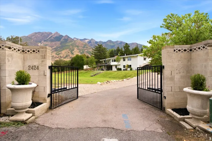 Gated entrance to the secluded Oakcrest Lane property with a dramatic Wasatch Mountain backdrop.