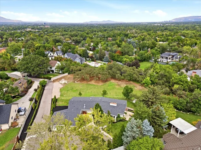 Aerial perspective highlighting the home’s spacious .54-acre setting and adjacent .61-acre buildable lot.