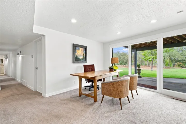 Flexible lower-level living space with built-in workspace and direct access to the backyard.