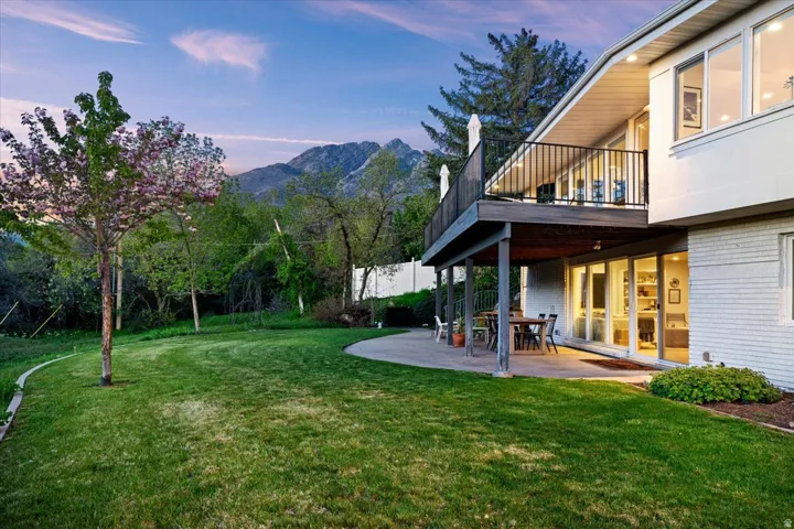 Spacious backyard with mature trees, mountain views, and walkout access from the lower level.