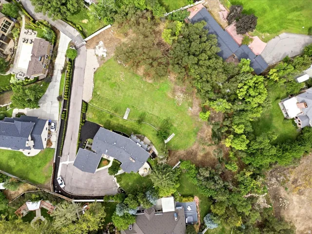 Overhead aerial showing the residence, expansive grounds, mature tree canopy, and end-of-lane setting.