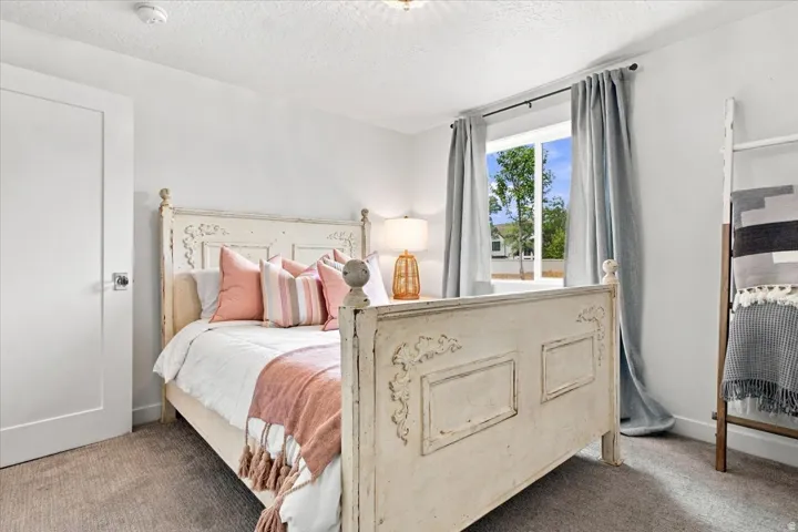 Lower-level bedroom with natural light, neutral finishes, and generous space.