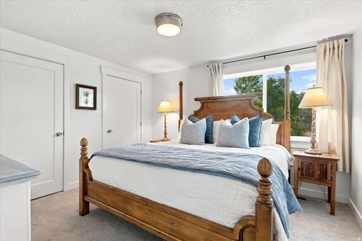 Spacious lower-level bedroom with natural light and neutral finishes.