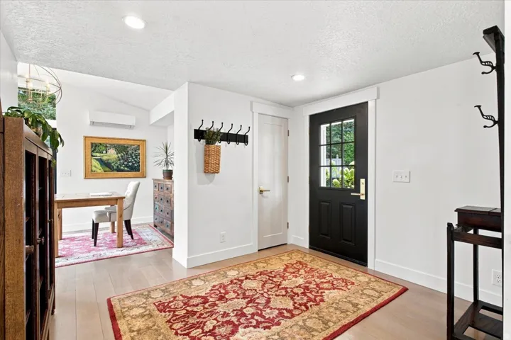 Bright main-level entry with hardwood floors and convenient access to the home office.