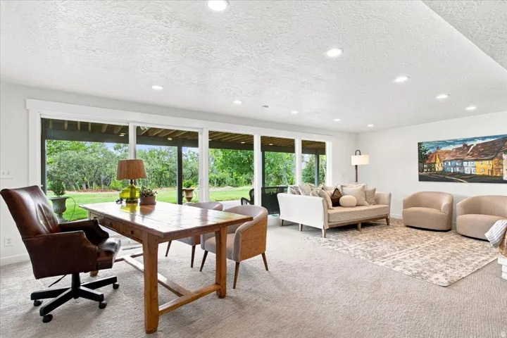 Spacious walkout lower-level family room with oversized windows and sliding doors opening to the backyard.