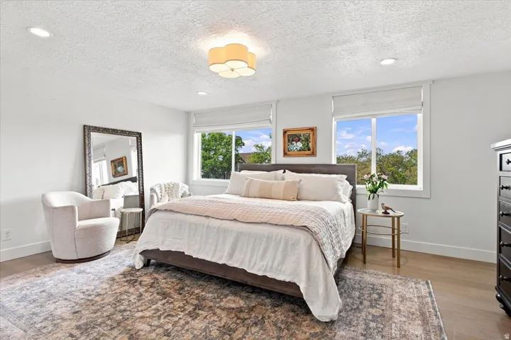 Main-level primary bedroom with abundant natural light and mountain views.