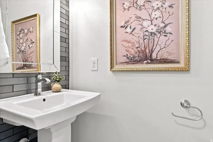 Convenient main-level powder bath with classic subway tile and pedestal sink.