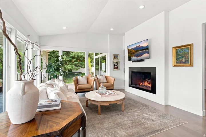 Walkout lower-level family room with contemporary linear fireplace, recessed lighting, and flexible living space.