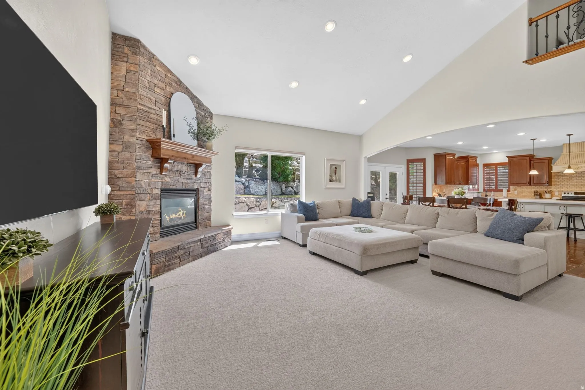 Stone-clad fireplace with a wood mantel
