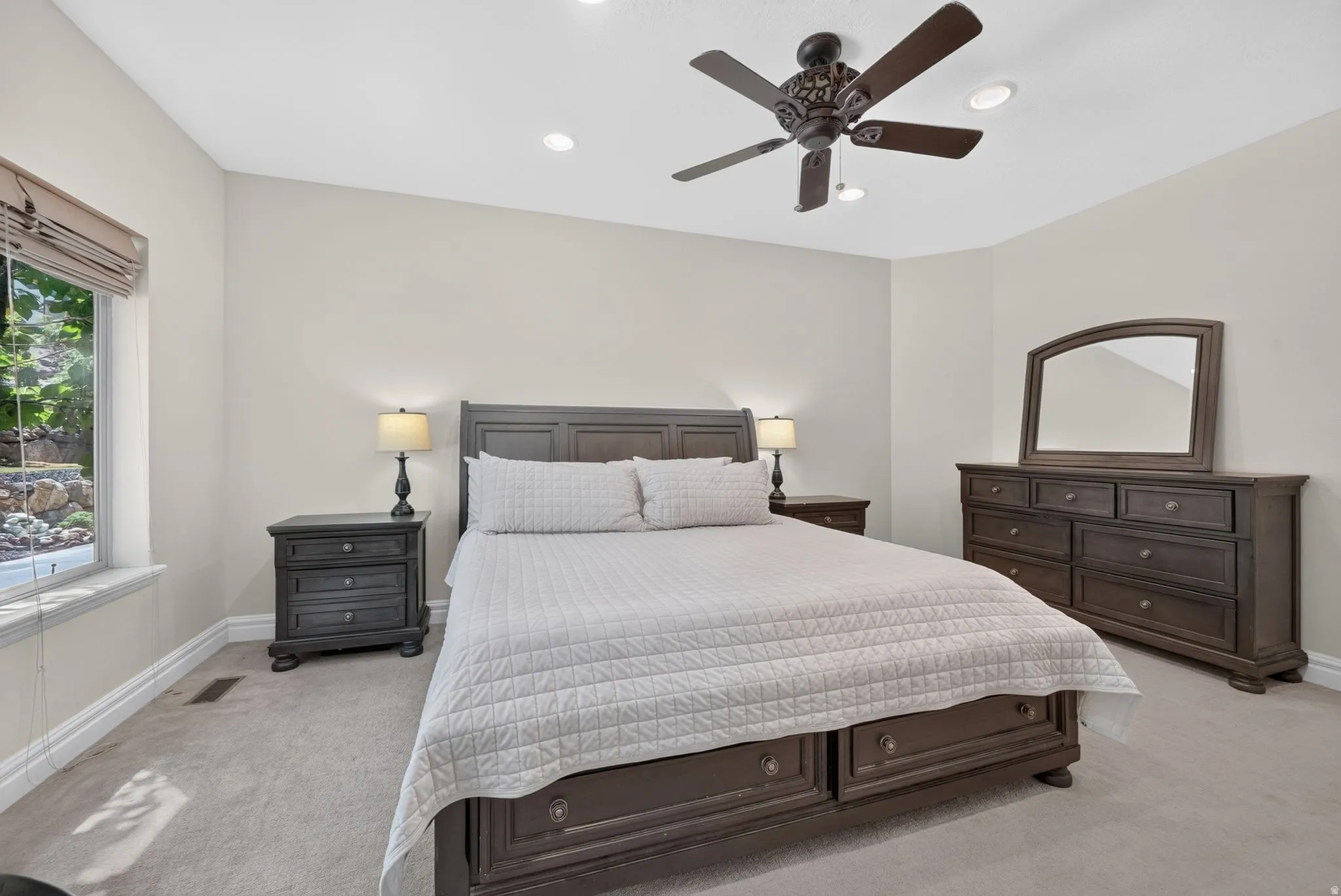 Recessed lighting, ceiling fan, carpeting, and window with outdoor scenery