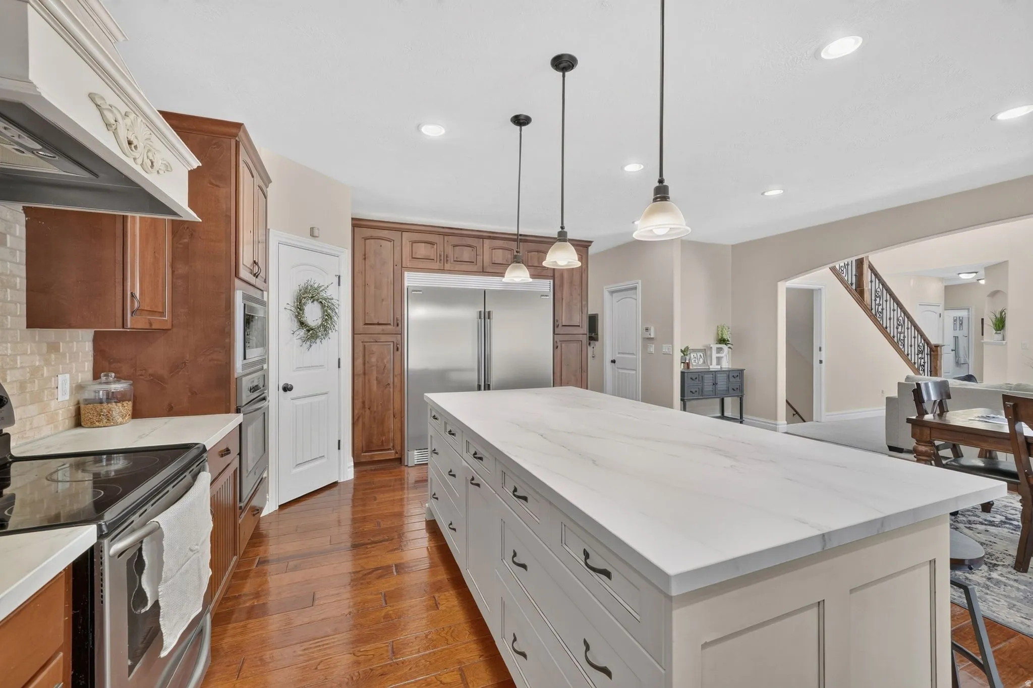 Expansive kitchen island with a stone-finish countertop