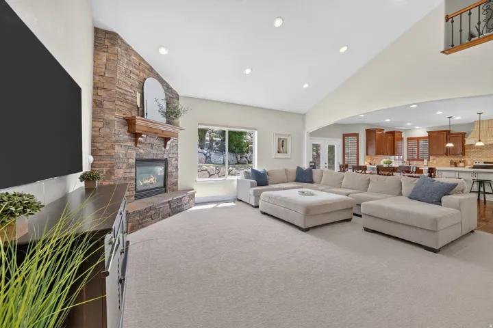 Stone-clad fireplace with a wood mantel
