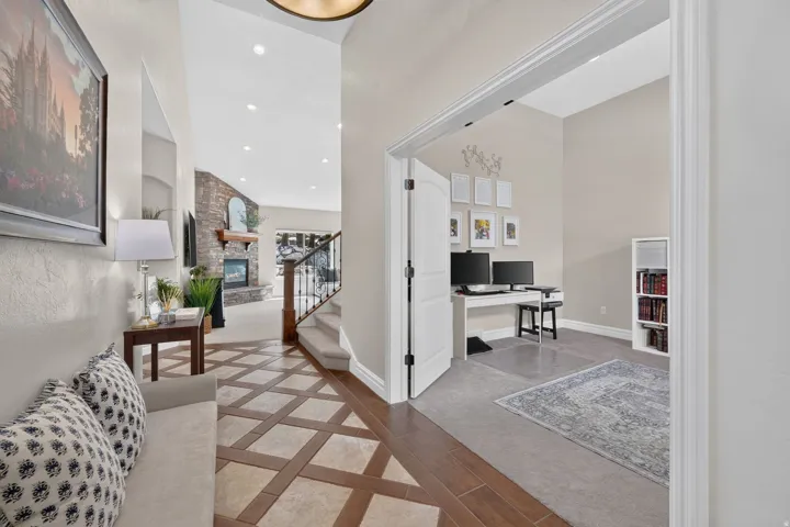 Grand entry featuring a patterned tile and wood-finish flooring