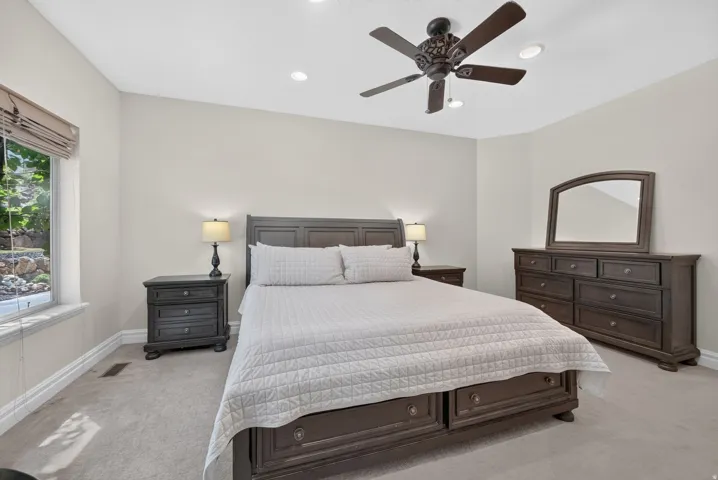 Recessed lighting, ceiling fan, carpeting, and window with outdoor scenery