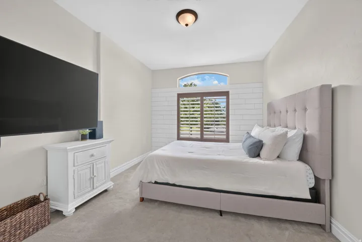Recessed window with plantation shutters and an arched transom window