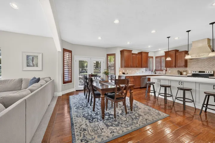 Wood-finish flooring, recessed lighting, and white walls