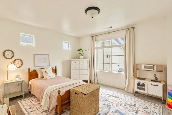 Neutral wall color, carpeted flooring, large window with blinds, recessed lighting, and additional high windows