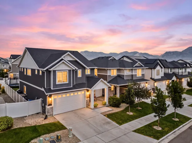 Two-story exterior with dark siding and white trim accents