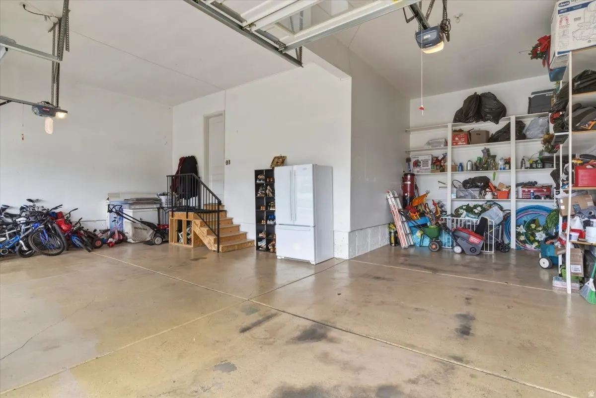 Expansive garage with painted concrete flooring and built-in shelving