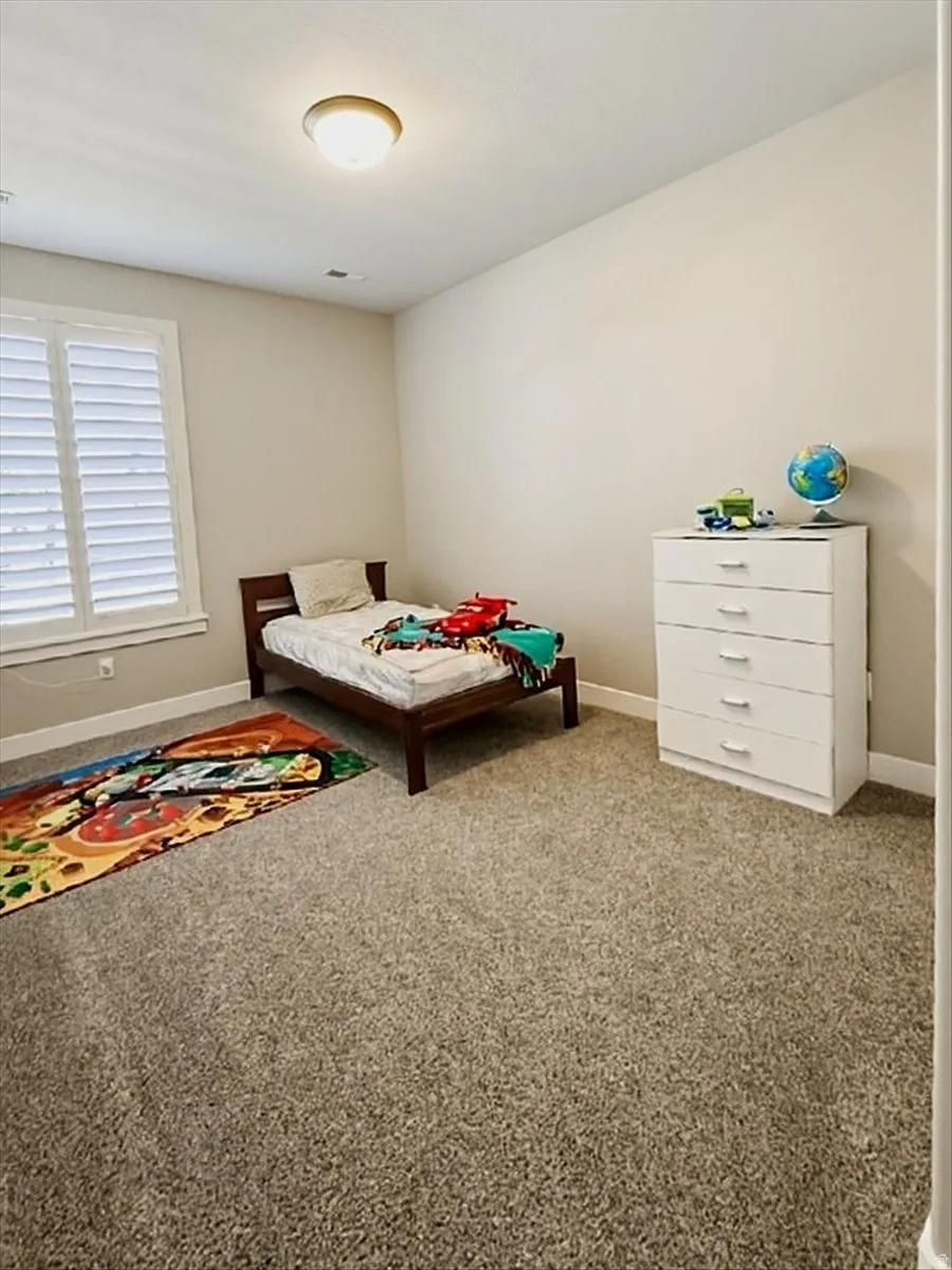 Neutral wall paint, recessed lighting, and carpeted flooring
