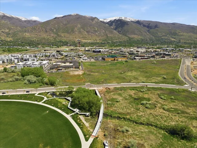 Expansive open land with paved access roads and mountain backdrop