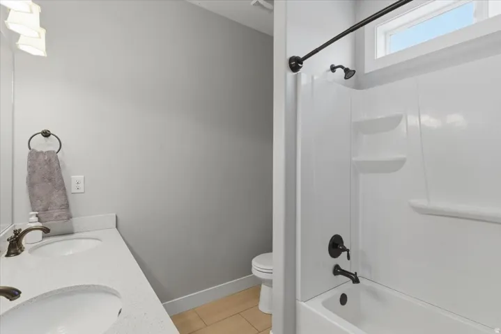 Dual vanity with white undermount sinks and light-colored countertops