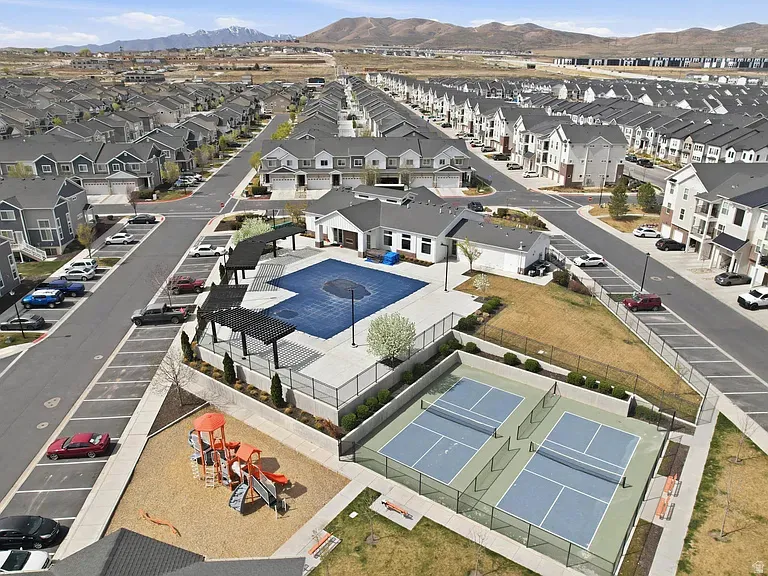 Community amenities featuring a swimming pool, clubhouse, playground, and dual pickleball courts