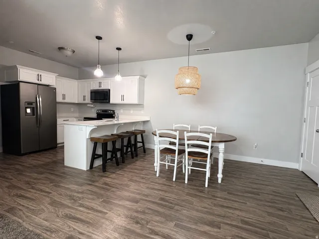 Open-concept living area with wood-finish flooring