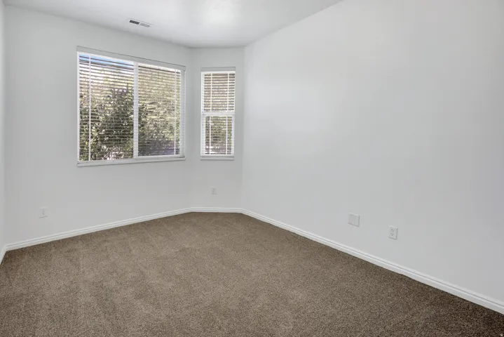 Bright interior with neutral carpeting and white wall paint