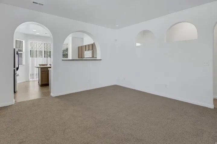 Archways, recessed wall niches, and neutral carpeting