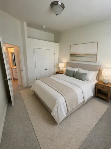 Upstairs bedroom. recessed ceiling light fixture, white paneled double doors, light-colored carpet, and an interior door