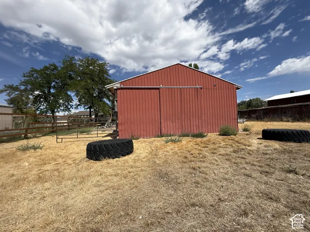 Red-sided barn structure featuring a sliding door
