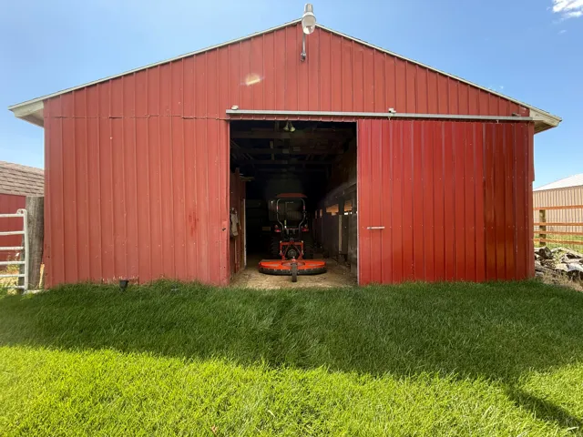 Red metal-sided barn with a gable roof