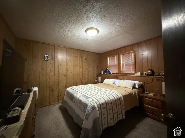 Wood-paneled walls with a textured ceiling and flush-mount lighting