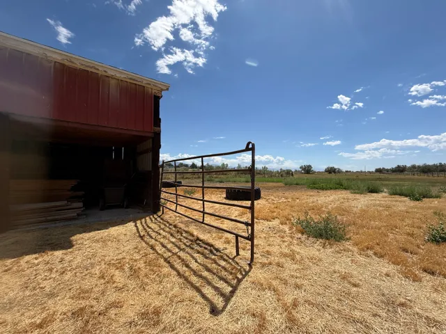 Red metal-sided barn structure with open interior