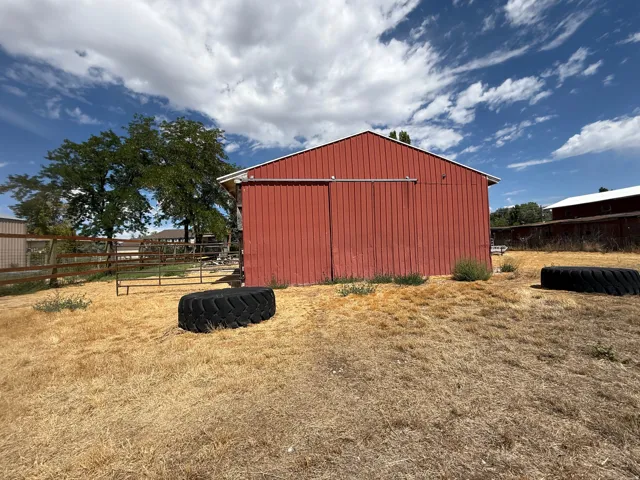 Red-sided barn structure featuring a sliding door
