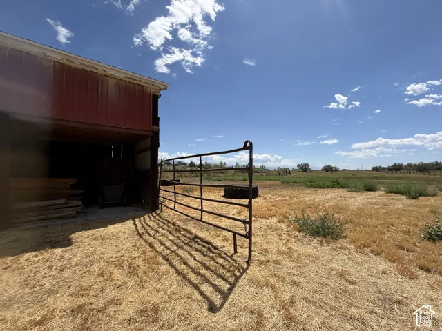 Red metal-sided barn structure with open interior