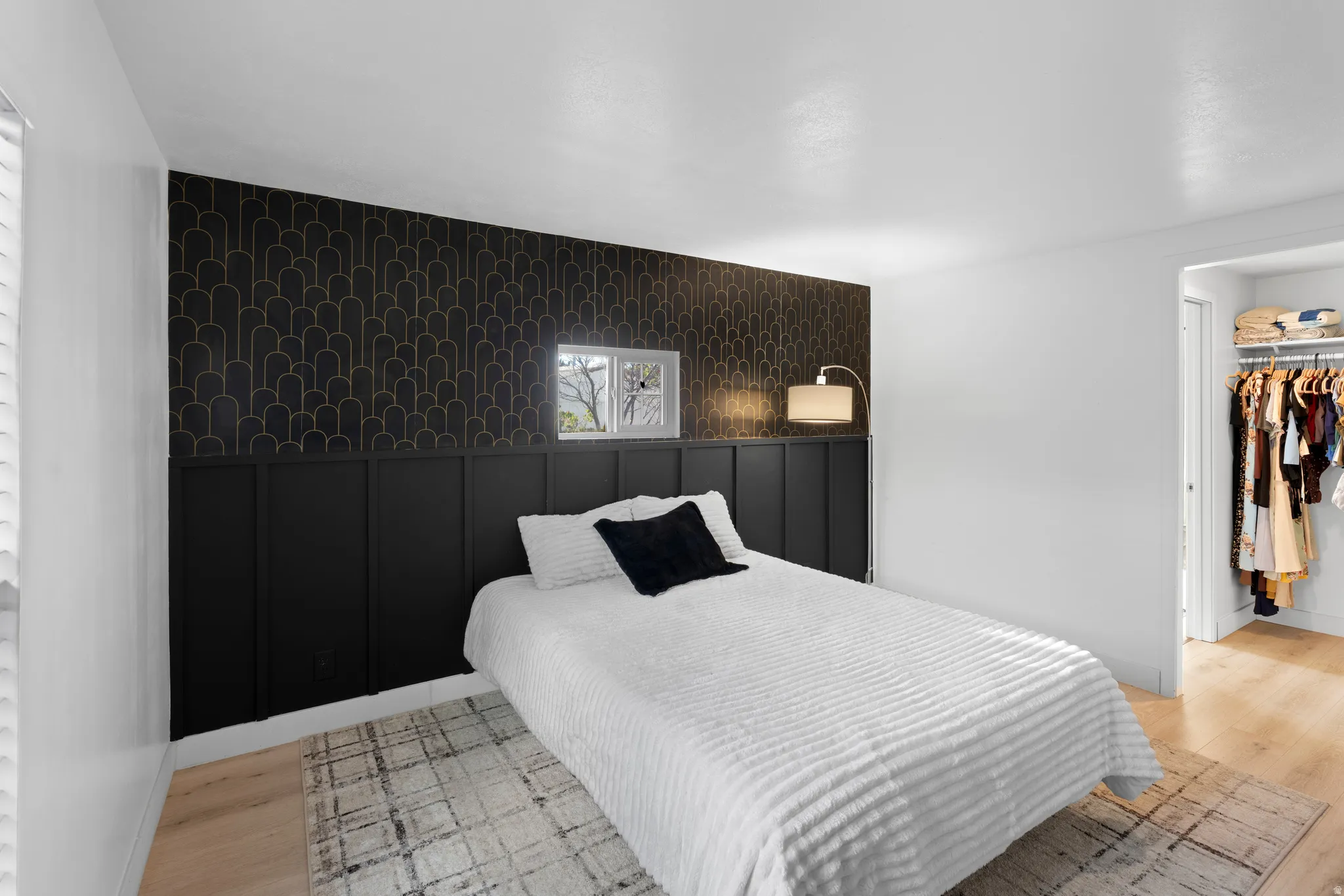 Accent wall with wainscoting and patterned wallpaper