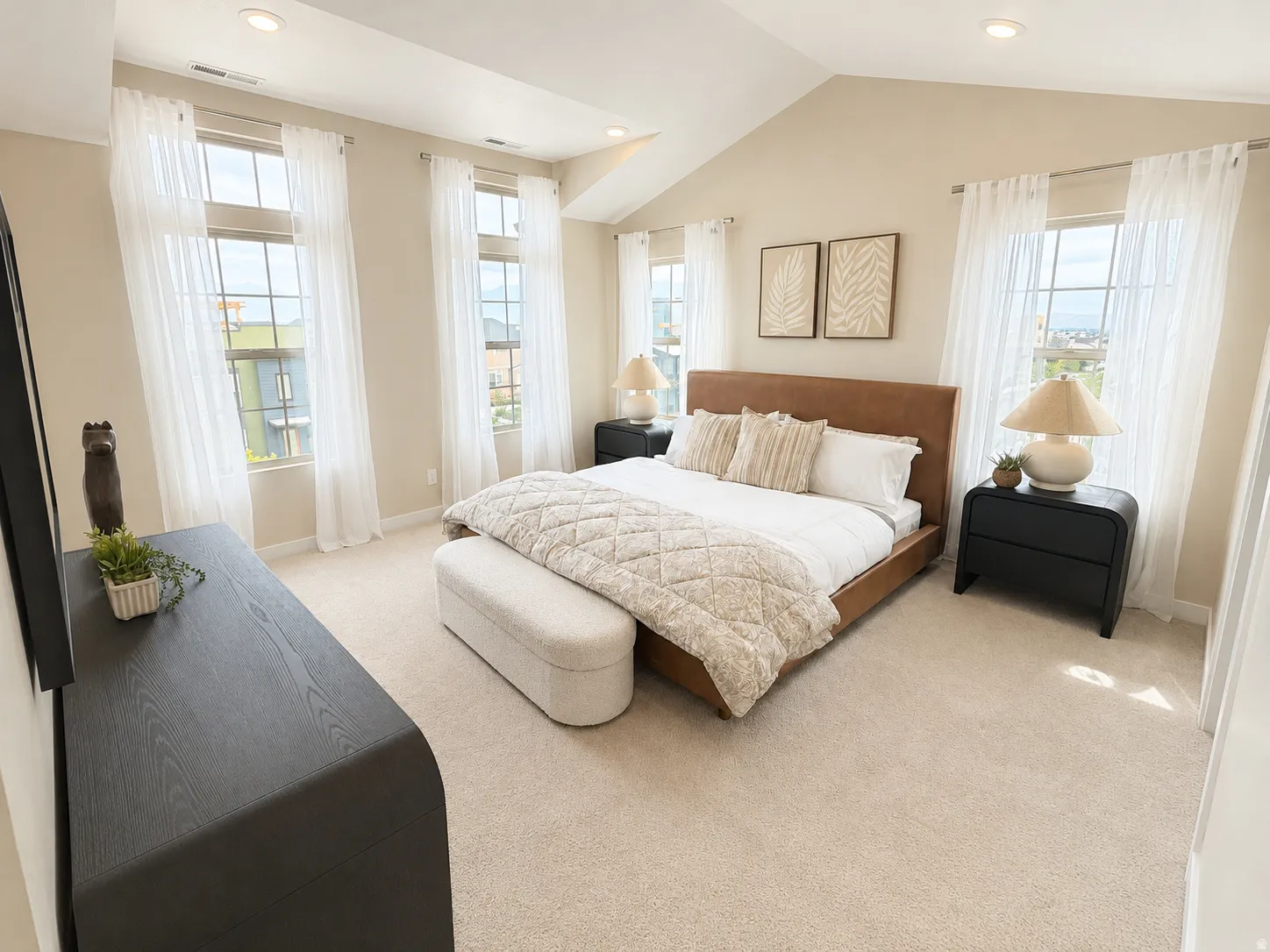 Vaulted ceiling, recessed lighting, and expansive windows