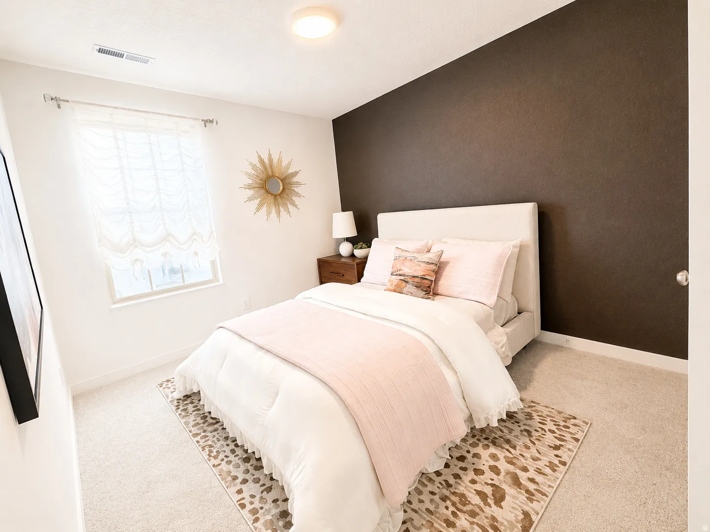 Carpeted room featuring a window, built-in light fixture, and a partial accent wall