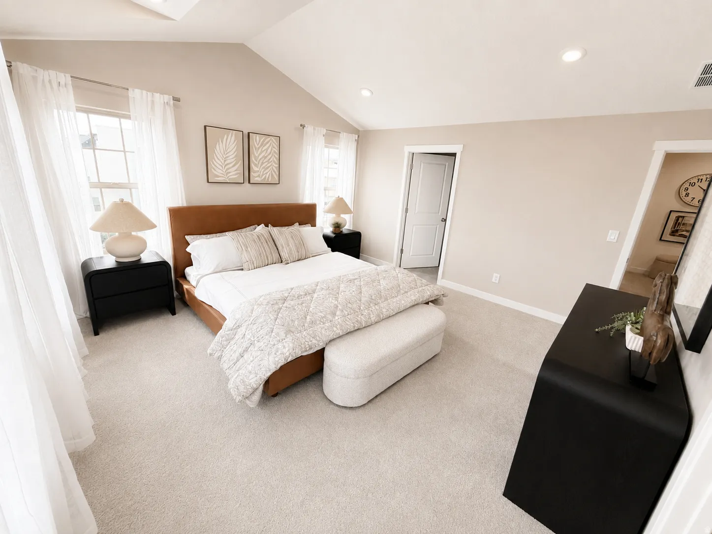 Vaulted ceiling with recessed lighting, light-toned carpet, and multiple windows