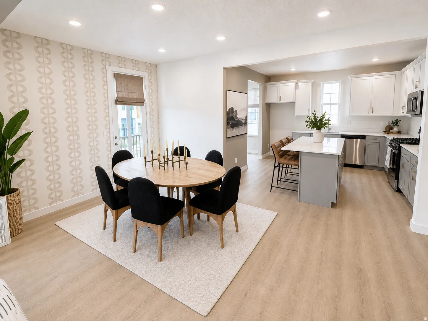 Open-concept layout featuring wood-finish flooring, recessed lighting, and a kitchen with stainless steel appliances