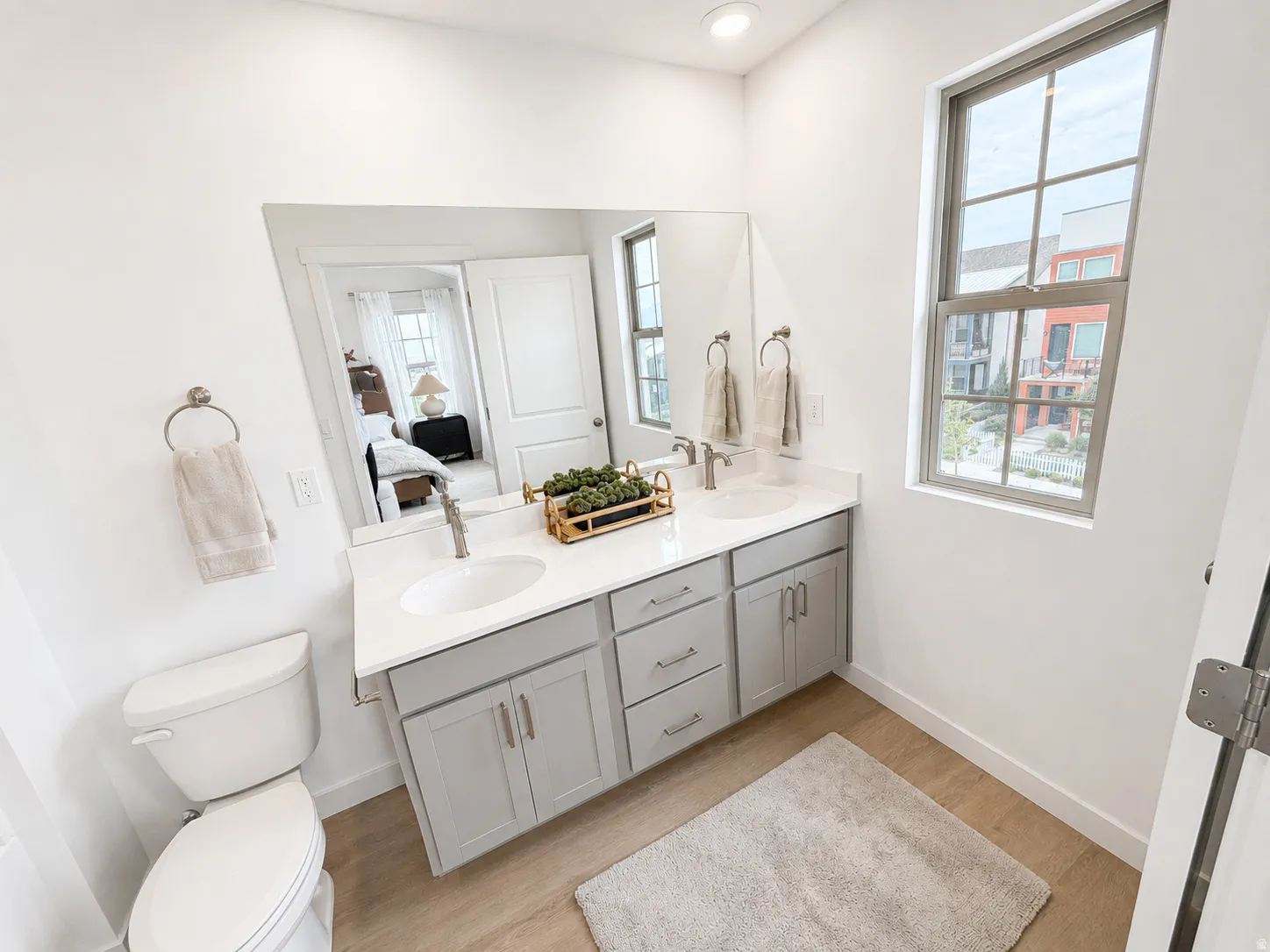 Dual vanity with undermount sinks and light gray cabinetry