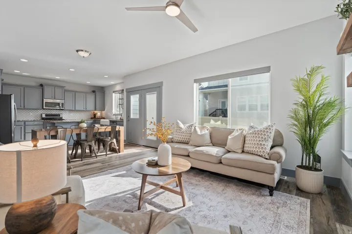Open-concept living area featuring wood-finish flooring, recessed lighting, and a ceiling fan