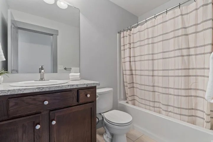 Dark wood-finish vanity with an integrated sink and light-toned countertop