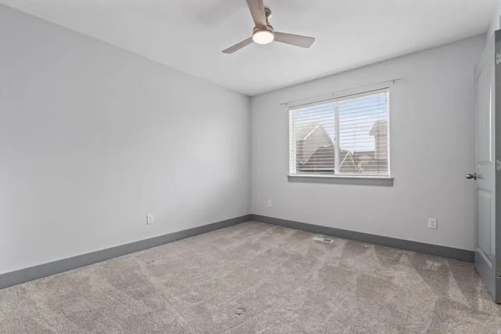 Recessed lighting, ceiling fan with integrated lighting, window with blinds, light gray wall paint, and gray carpeting