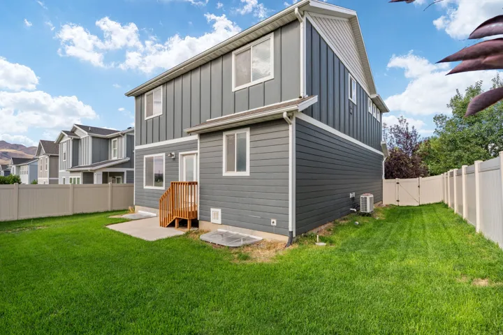 Expansive green lawn with a privacy fence