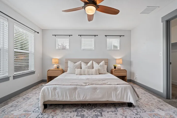 Recessed lighting, ceiling fan with integrated light fixture, multiple windows with blinds, built-in closet with shelving