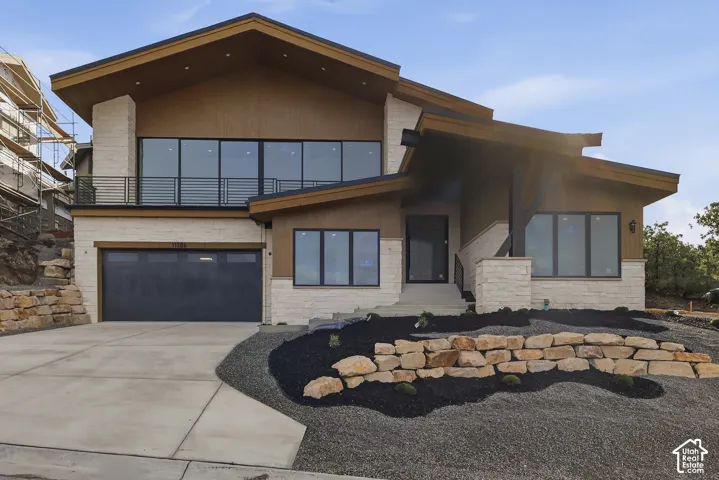 Contemporary exterior with stone veneer and wood-finish siding